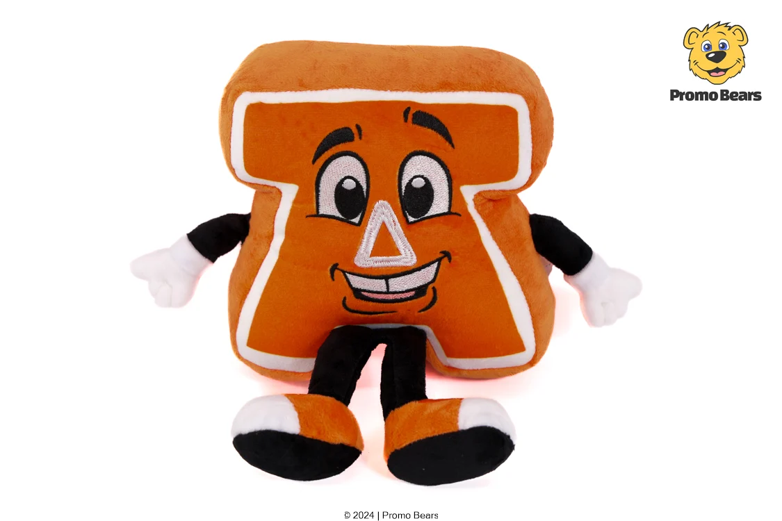 Orange plush letter A character with a smiling face, arms and legs, sitting on a white background.